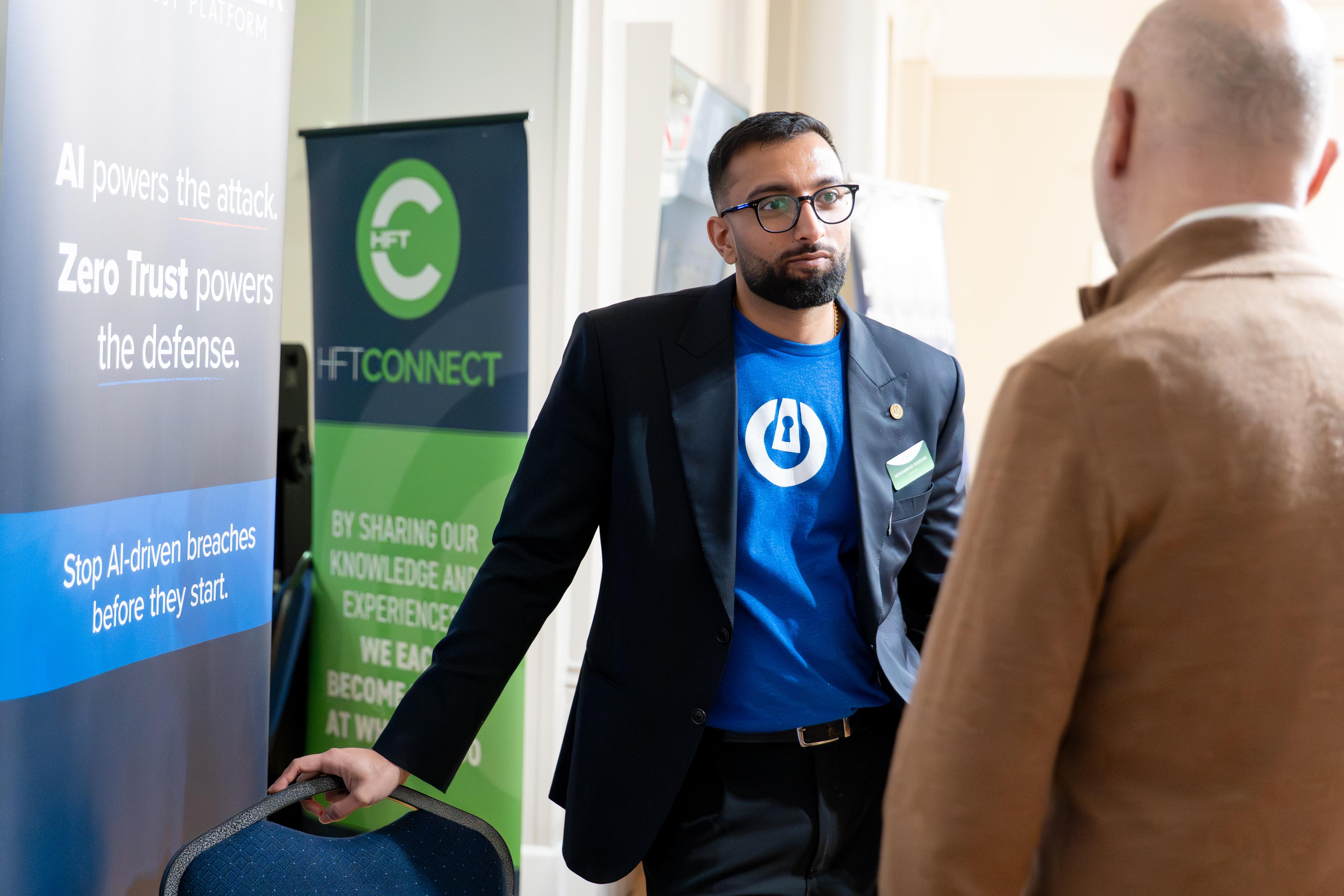 ThreatLocker representative Mohammad Hussain chatting with Members.